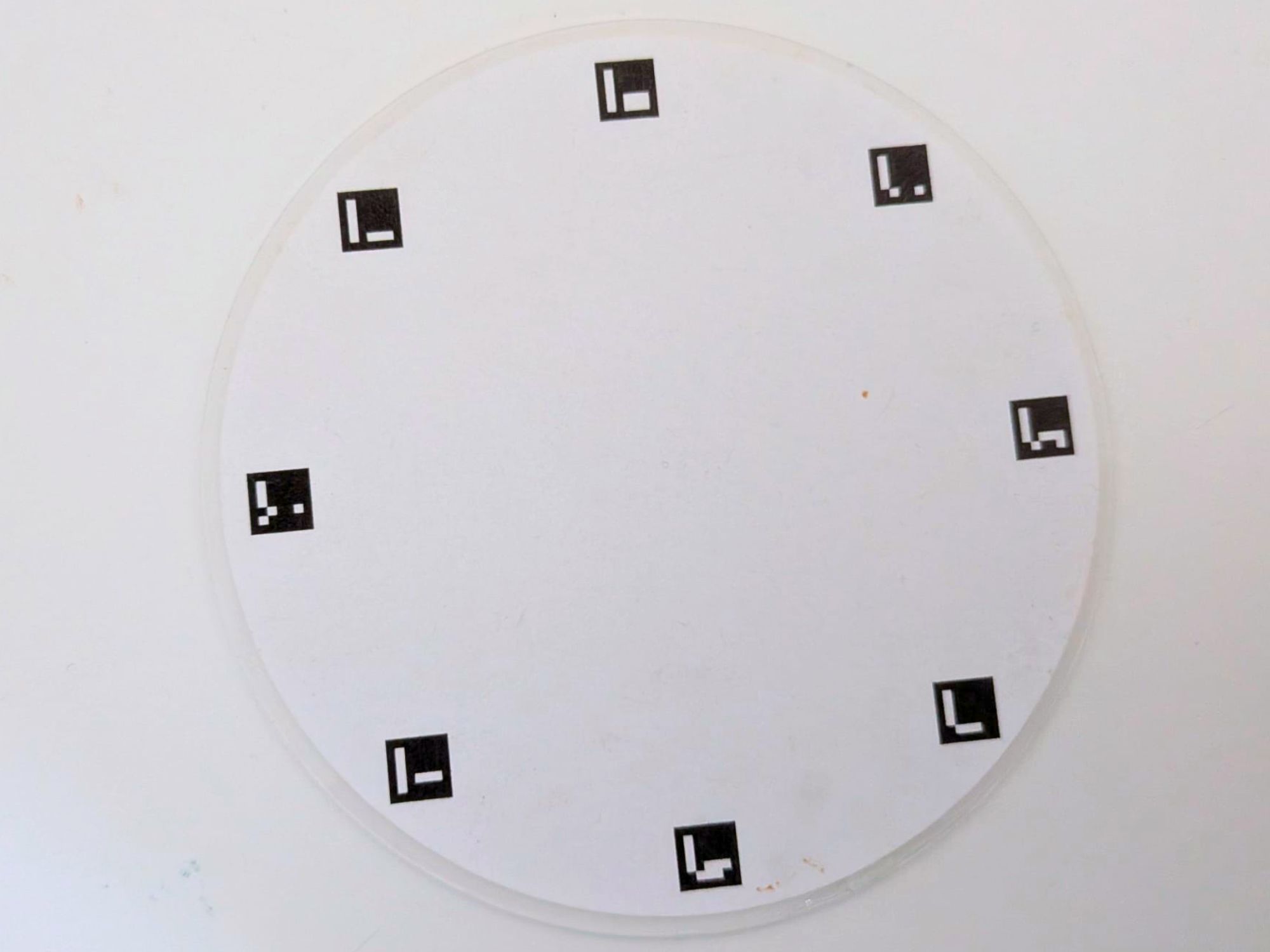 Petiole Pro calibration plate for leaf area — a round white plate with 8 ArUco markers around the edge.